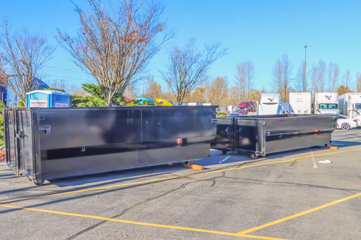 Professional dumpster rental service with roll-off container on residential driveway in Wauchula